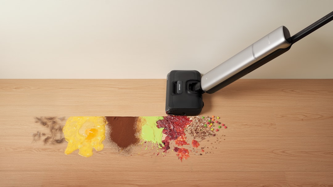 On the wooden floor, a Dreame wet dry vacuum cleans up common household spills, handling different types of everyday messes.